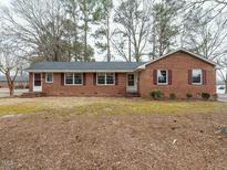 Charming brick ranch-style home with manicured lawn and mature trees at 431 Mattox St, Wendell, NC 27591