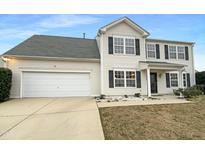 Charming two-story home features a clean design, two-car garage, and well-maintained front yard at 4900 Alenja Ln, Raleigh, NC 27616