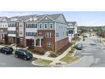 Stylish townhome featuring brick and siding facade with well-maintained landscaping at 547 Gateway Townes Blvd, Wake Forest, NC 27587