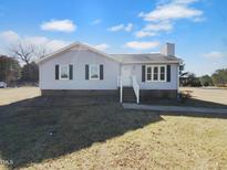 Charming one-story home with light blue siding, black shutters, and a well-maintained front lawn at 6825 Pulley Town Rd, Wake Forest, NC 27587