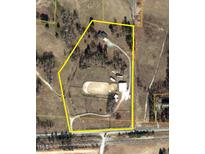 Aerial view showcasing the property's layout, including the house, stables, and outdoor riding arena at 7027 Old 421 Rd, Liberty, NC 27298