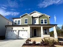 Charming two-story home featuring a two-car garage and craftsman style front porch at 749 Aristocrat Ln, Knightdale, NC 27545