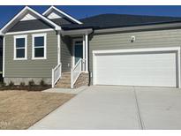 Charming single-Gathering home featuring a two-car garage and neatly landscaped front yard at 813 Emmer St, Rolesville, NC 27571