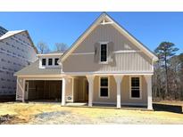 New construction featuring light siding, a two-car garage, and columned front porch at 9169 Dupree Meadow Dr # 26, Angier, NC 27501