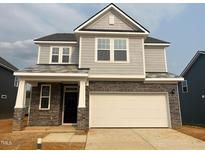 Charming two-story home with stone accents and a two-car garage at 107 Willow Cameron Way, Angier, NC 27501