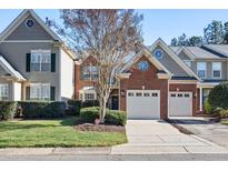 Charming brick townhouse with a two-car garage and well-maintained landscaping in a desirable neighborhood at 11213 Presidio Dr, Raleigh, NC 27617