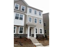 Charming three-story townhome with stone accents and neutral siding at 2005 Sequoia Ln, Durham, NC 27703