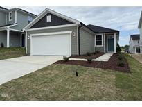 Charming single-story home with a two-car garage and a well-manicured front yard at 2644 Pivot Ridge Dr, Raleigh, NC 27616