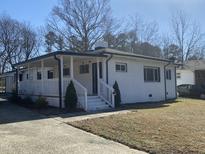 Charming white brick home with a covered porch and well-maintained front yard at 2807 Beechwood Dr, Durham, NC 27707