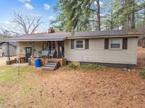 Charming home with a cozy front porch and a well-maintained yard surrounded by trees at 372 Pocomoke Rd, Franklinton, NC 27525