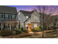 Charming two-story home featuring manicured landscaping and a welcoming brick entryway at dusk at 5618 Wade Park Blvd, Raleigh, NC 27607