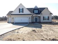 Charming single-Gathering home featuring a spacious two-car garage and a manicured lawn at 622 Tart Town Rd, Dunn, NC 28334