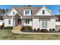 Charming white home with a well-manicured lawn and covered entryway showcasing its inviting curb appeal at 654 Christian Light Rd, Fuquay Varina, NC 27526