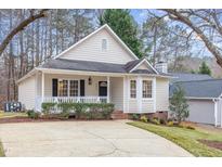 Charming home with a well-maintained lawn, inviting front porch, and a driveway at 904 Amersham Ln, Wake Forest, NC 27587