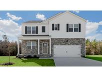 Charming two-story home featuring stone accents, white siding, black shutters and a well-manicured front lawn at 93 Fair Child Rd, Spring Lake, NC 28390