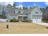 Charming two-story home featuring stone accents, a welcoming entrance, and a two-car garage at 97 Buckstone Pl, Willow Springs, NC 27592