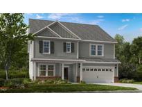 Charming two-story home with gray siding, shutters, attached garage, and a beautifully landscaped front yard at 100 Cloud Berry Ln, Holly Springs, NC 27540