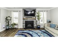 Cozy living room showcasing a stone fireplace and natural light, paired with stylish décor at 130 Kimberling Dr, Franklinton, NC 27525