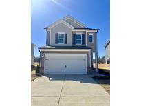 Charming two-story home with a two-car garage and manicured front yard at 208 Bruce Dr Dr, Dunn, NC 28334