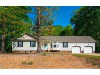 Charming single-story home featuring a two-car garage, vinyl siding, and a well-maintained lawn at 29 Texas Cattle Dr, Clayton, NC 27520