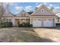 Charming home with three car garage, manicured lawn, and inviting curb appeal at 2921 Lawson Walk Way, Rolesville, NC 27571