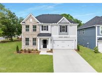 Charming two-story home featuring a brick and siding exterior, a well-manicured lawn, and an attached two-car garage at 376 Buckhorn Branch Park # 38, Clayton, NC 27520