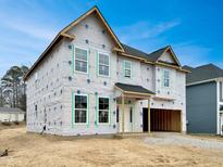 New construction two-story home featuring white windows and an attached two-car garage at 376 Buckhorn Branch Park # 38, Clayton, NC 27520