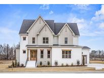 Stunning two-story home with white brick, accented by wooden trim and beautiful landscaping at 3812 Cobbler View Way, Fuquay Varina, NC 27526