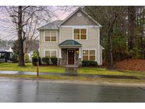 Charming two-story home featuring stone accents, a covered porch, and a well-maintained front lawn at 4102 Panther Creek Pkwy, Durham, NC 27704
