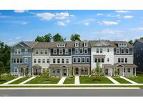 Charming new construction townhomes featuring different stylish paint colors and cozy front porches at 427 Rowe Way, Knightdale, NC 27545