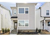 Modern two-story home featuring gray siding, brick foundation, and bright white window trim at 485 Wendover Pkwy, Pittsboro, NC 27312