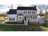 Charming two-story home with a well-maintained lawn and classic architectural details at 6309 Charmco Ct, Wake Forest, NC 27587