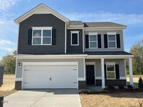 Two-story home features a two-car garage and a mix of traditional and craftsman design elements at 68 Victory View Ter, Smithfield, NC 27577