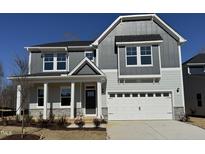 Beautiful two-story home with a two-car garage, covered porch, and attractive gray and white exterior at 741 Aristocrat Ln, Knightdale, NC 27545