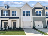 Charming new townhomes with Hardie siding, Craftsman-style doors and one car garages offer a touch of modern living at 84 Ripple Way # 313, Clayton, NC 27520