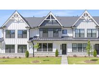 Stylish townhouse with a white facade, gray accents, and a well-manicured lawn at 905 Myers Point Dr, Morrisville, NC 27560