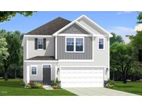 Charming two-story home with gray and white siding, complemented by lush landscaping and a spacious two-car garage at 97 Willow Cameron Way, Angier, NC 27501