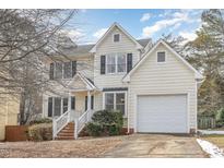 Charming two-story home with a well-maintained lawn, attached garage, and inviting entryway at 1040 Sheetbend Ln, Raleigh, NC 27606