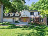 Charming two-story home with brick accents, black shutters, and a well-manicured lawn at 1305 Glen Eden Dr, Raleigh, NC 27612