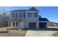 Charming two-story home with a two-car garage and neutral siding, situated on a spacious lot at 2534 Whitetail Rd, Nashville, NC 27856