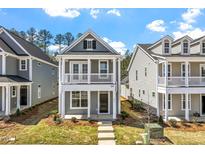 Charming two-story home with a welcoming front porch and balcony, complemented by beautifully maintained landscaping at 272 White Oak Garden Way # 209, Garner, NC 27529