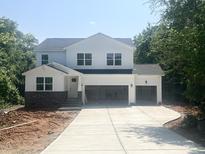 New two-story home with a large driveway and a two-car garage ready to be transformed into your dream home at 362 Barbour Farm Ln, Four Oaks, NC 27524