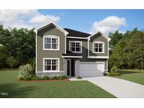 Charming two-story home with stone accents, attached garage, and beautifully landscaped front yard at 416 Barbour Farm Ln, Four Oaks, NC 27524