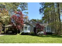 Charming home with a well-manicured lawn, carport, and beautiful trees in a tranquil setting at 4909 Lancashire Dr, Raleigh, NC 27613