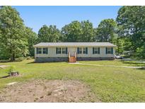 Charming single-story home with light siding, complemented by teal shutters and a well-maintained lawn at 610 Apple St, Gibsonville, NC 27249