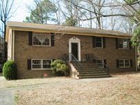 Charming two-story brick home with a well-manicured lawn and inviting front entrance at 6112 Yellowstone Dr, Durham, NC 27713