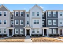 Modern townhome with a mix of white and gray siding, complemented by stone accents on the lower facade at 6318 Perry Creek Rd, Raleigh, NC 27616