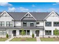 Charming townhomes with modern farmhouse appeal, featuring white siding and a well-manicured lawn at 913 Myers Point Dr, Morrisville, NC 27560