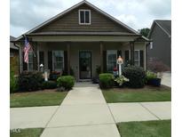 Charming single-story home with a welcoming front porch, well-manicured landscaping, and an American flag at 103 Bella Sq Sq, Smithfield, NC 27577
