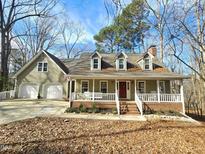Charming two-story home with a welcoming front porch and a two-car garage at 2024 Fox Den, Clayton, NC 27527
